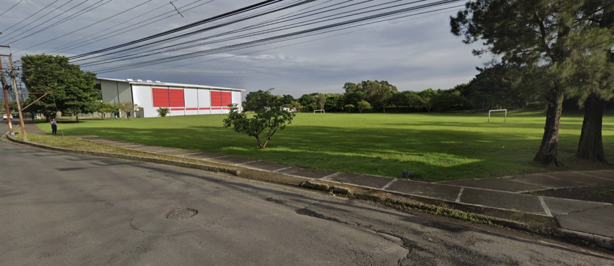 La zona verde del club junto al colegio, con espacio para parquear